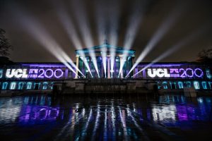A photo of UCL Portico with the test "UCL 200" lit up on either side
